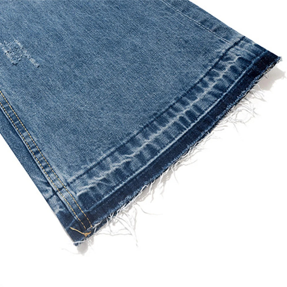 Blue Ripped Denim Flare Jeans — fabric close-up